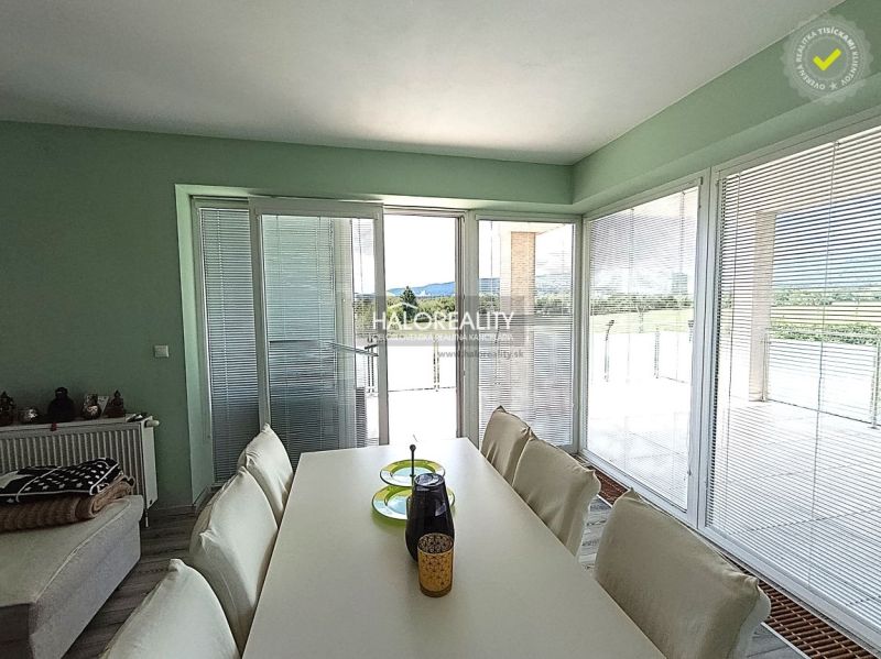 Dining area in a 3-room apartment with a view and seating.