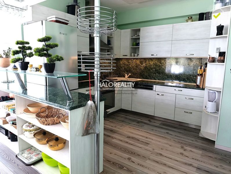 A kitchen with marble tiles, a wooden decor floor and counter, 3-room apartment.