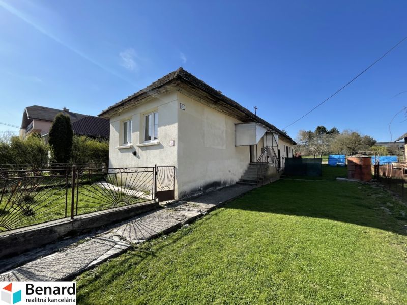 A family house on Tehelná Street in Drienov, surrounded by a well-maintained garden and a fence.