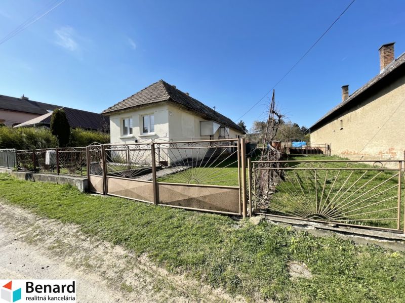 A family house on Tehelná Street in Drienov with a grassy yard and a fence.