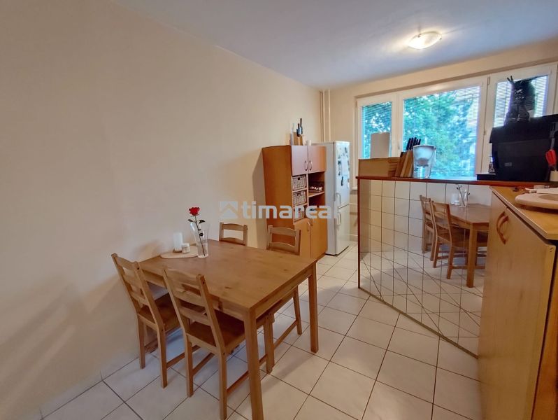 Dining area with a table and chairs in a 2-room apartment.