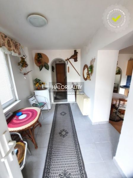 Interior of a family house with a tiled floor, walkway, and decorations.