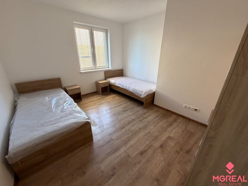 A children's room in a 3-room apartment with beds and a wooden decor floor.