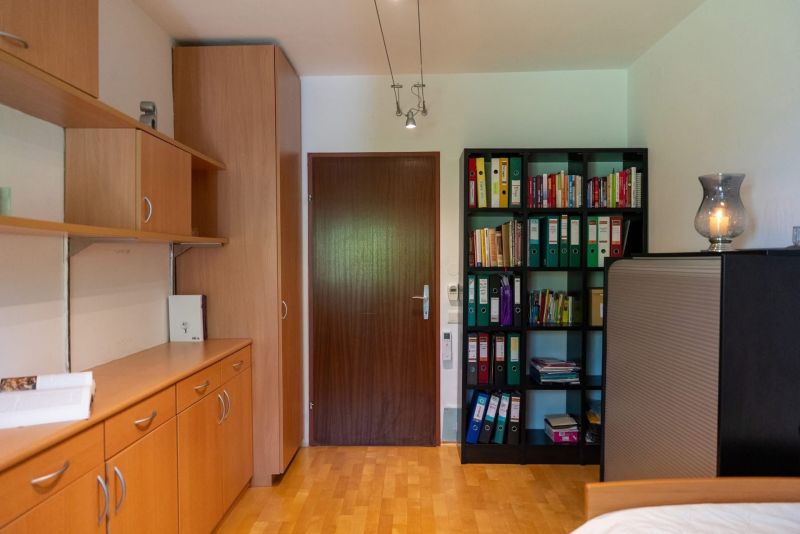 Wooden floor decor, built-in cabinets, and bookshelves in a 3-room apartment.
