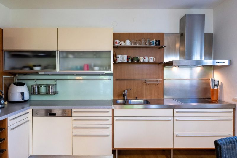A stylish kitchen with a wooden decor floor in a 3-room apartment.