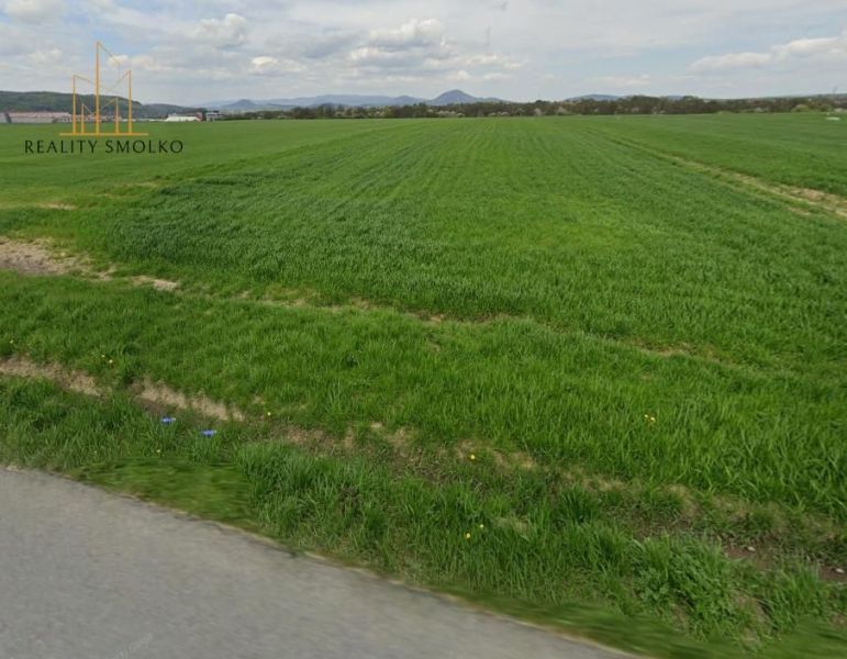 A vast green field suitable for residential plots around Záborské.