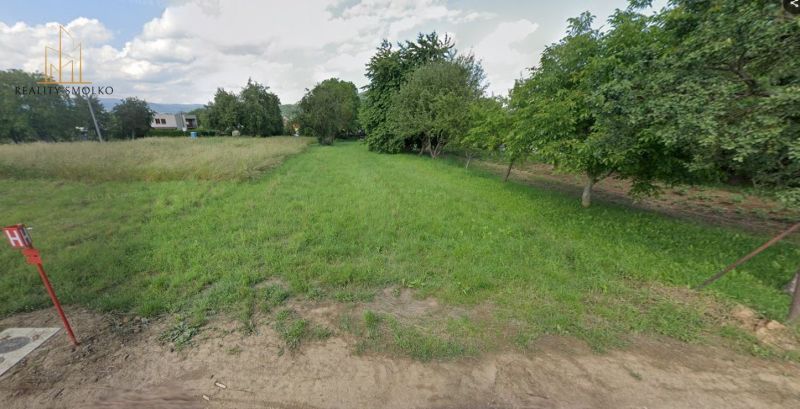 Land in Medzany suitable for living, with greenery and trees in the background.