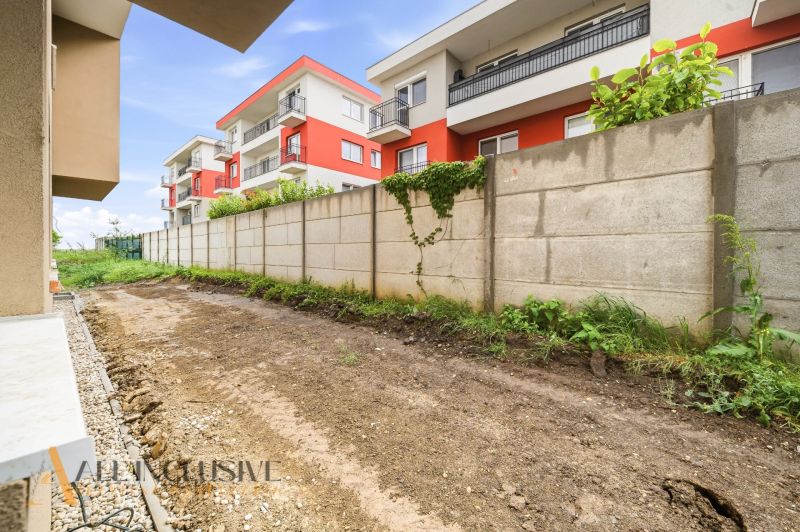 A garden at a 3-room apartment in Senec on Dlha Street, with a view of the apartment buildings.