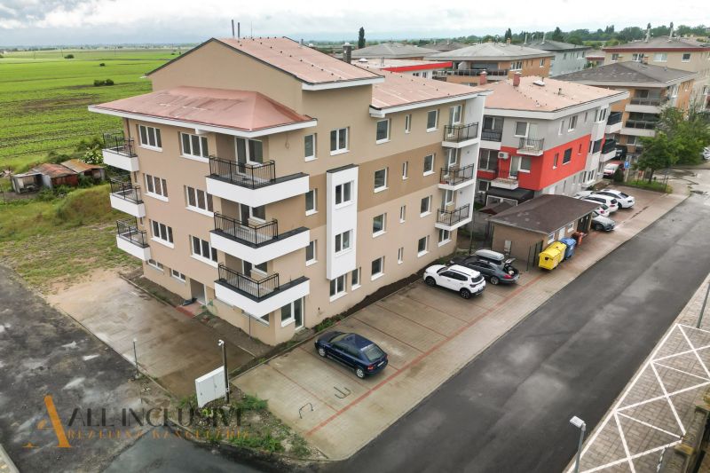 Apartment building in Senec on Dlhá Street with parked cars and surroundings.