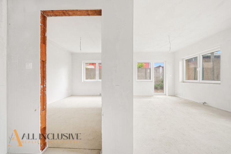 A spacious room in a 3-room apartment with large windows and an open passage.