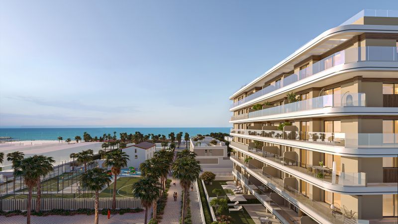 A view of the coastal buildings and palm trees in El Puig near the two-bedroom apartments.