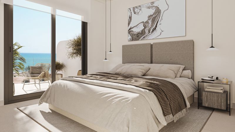 Bedroom in a 2-room apartment with a sea view, neutral colors, modern furniture.