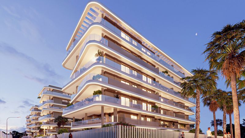 Modern architecture with elegant balconies surrounded by palm trees in the city of El Puig.