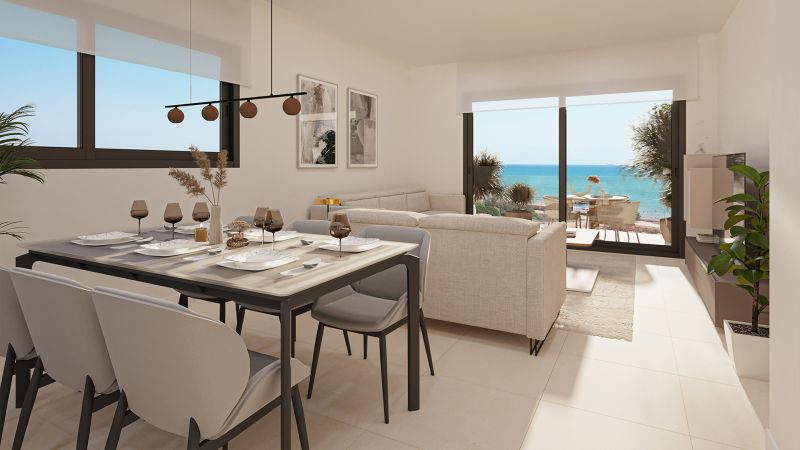 Interior of a 2-room apartment with a dining table, sofa, and sea view.