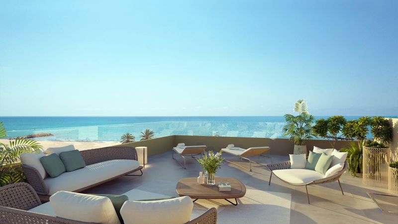 Terrace of a 2-bedroom apartment in El Puig with a sea view, rattan furniture.
