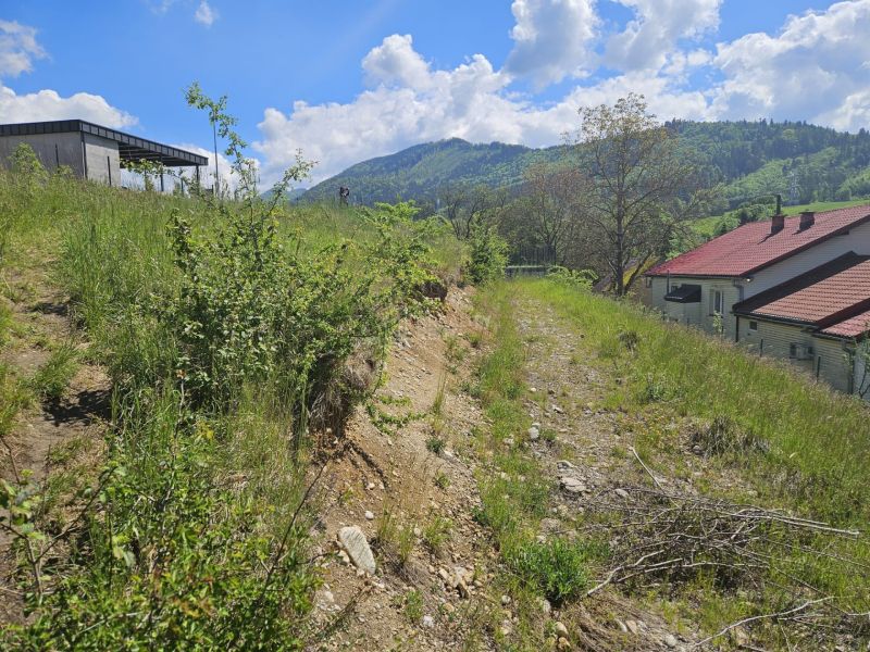 Plots - living in Rozbehov, Varín with a view of the mountainous landscape and a house with a gabled roof.