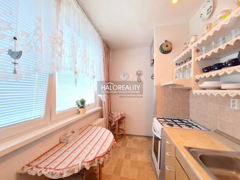 A kitchen in a 2-room apartment with wooden decor and cozy furnishings.