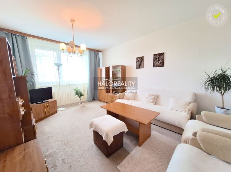 Living room in a two-room apartment with light furniture and a carpet.