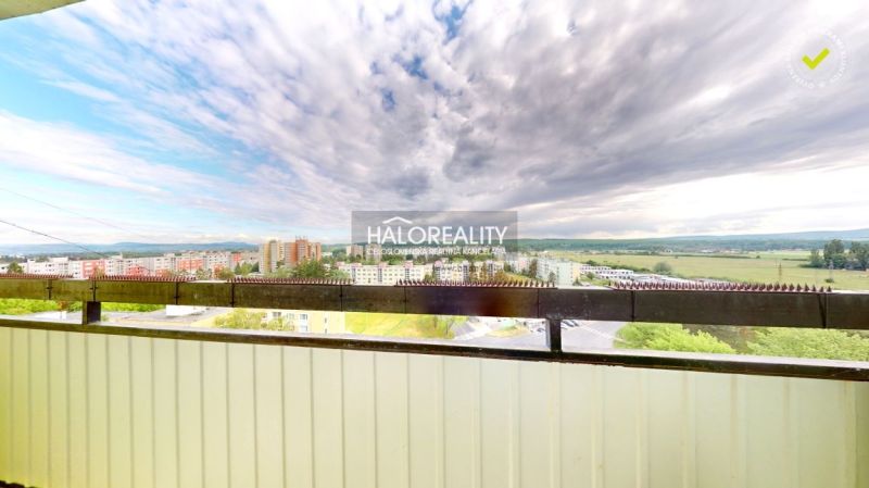 View from the balcony of a 2-room apartment in Lučenec with a panorama of the city and the sky.