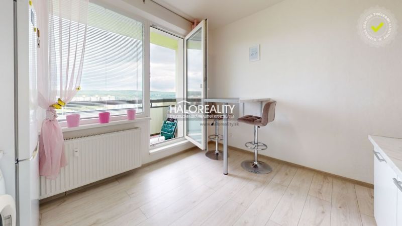 Bright kitchen with a bar counter in a 2-room apartment, floor with wood decor.