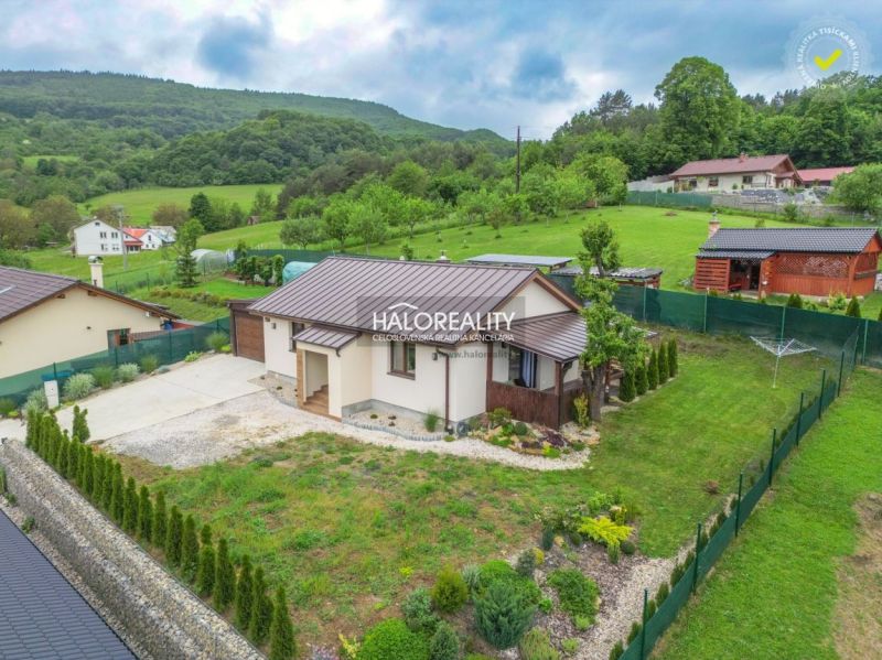 A family house in Dohňany with a pleasant garden, surrounded by greenery and hills in the background.
