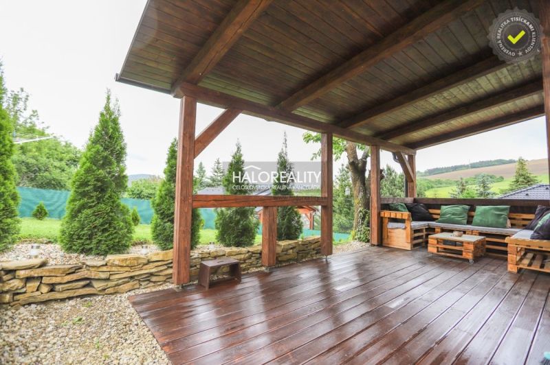 The terrace of a family house in Dohňany with a wooden decor and a view of the garden.