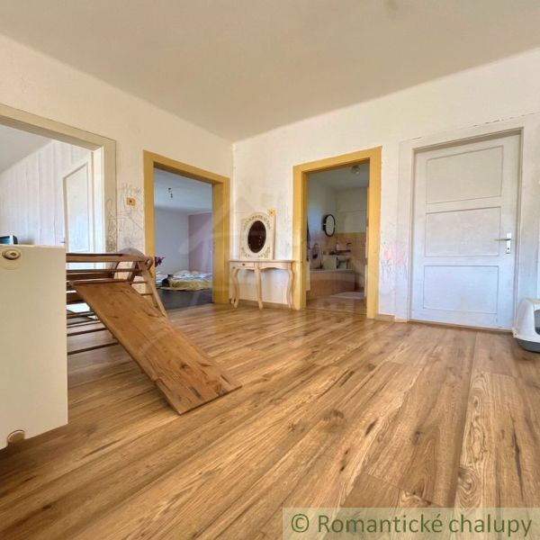 Interior of a family house with a wooden decor floor and wooden door frames.