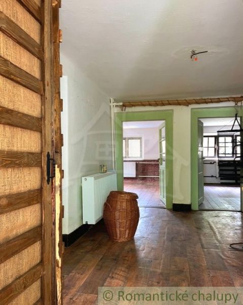 Interior of a family house with a wooden decor floor and a wicker basket in the hallway.