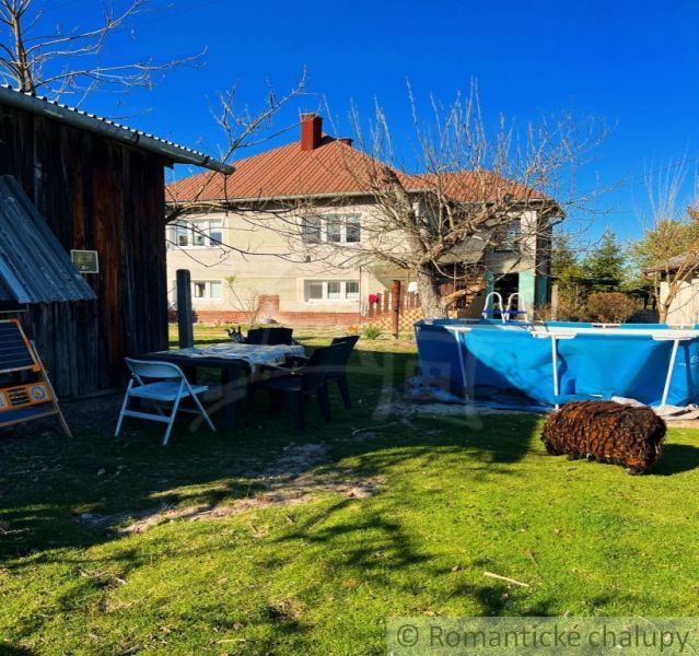 The courtyard of a family house in Nové Hony with a swimming pool and garden seating.