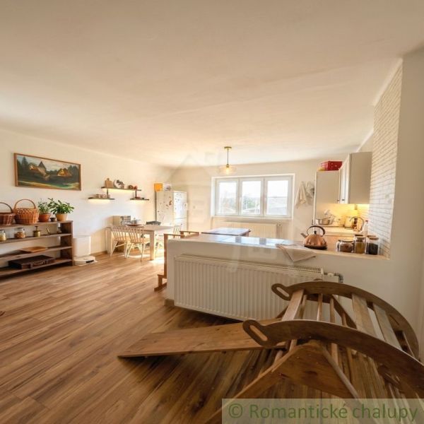 A kitchen in a family house with wooden decor, where light decorations dominate.