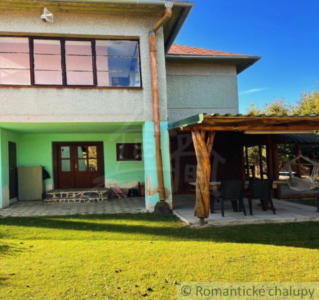 A family house in Nové Hony with a terrace, green lawn, and outdoor seating.