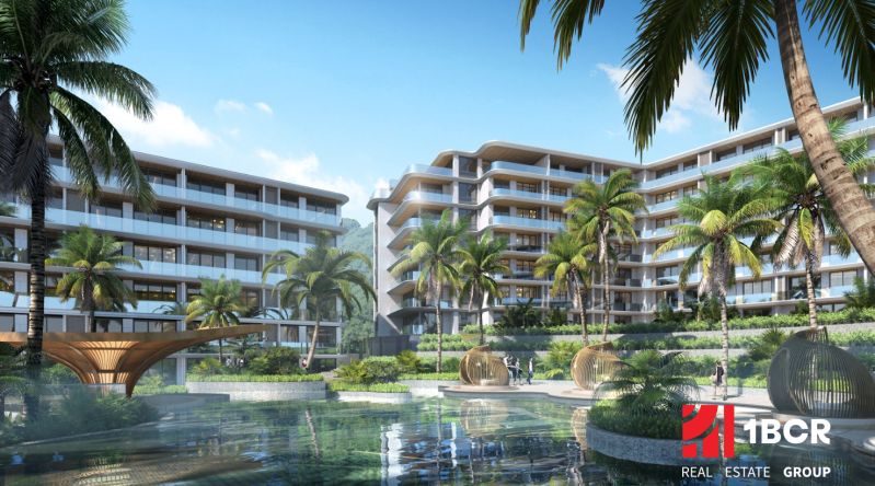 Apartment construction with a pool and palm trees in the city of Phuket.