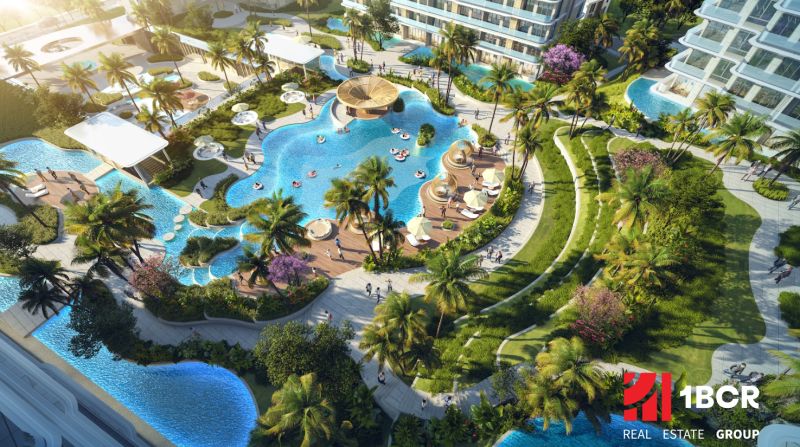 Apartment construction in Phuket with pools amidst greenery and palm trees.