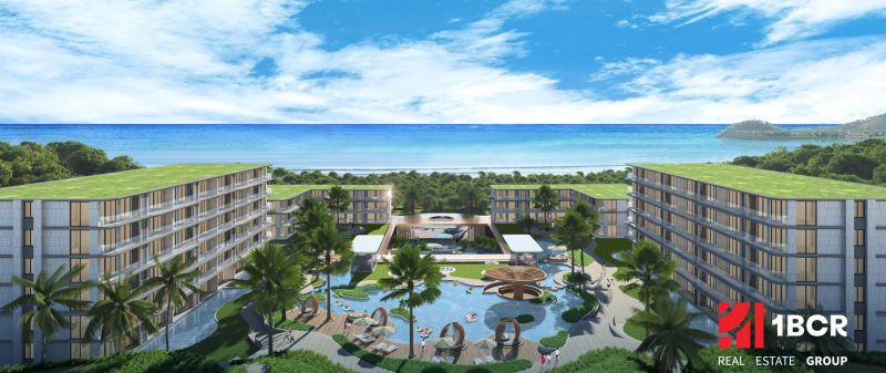A view of apartment construction in Phuket by the beautiful coastline with palm trees.