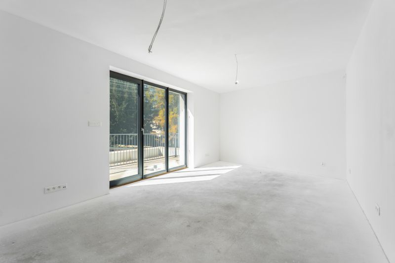 A spacious room with glass doors in a family house, view of the terrace.