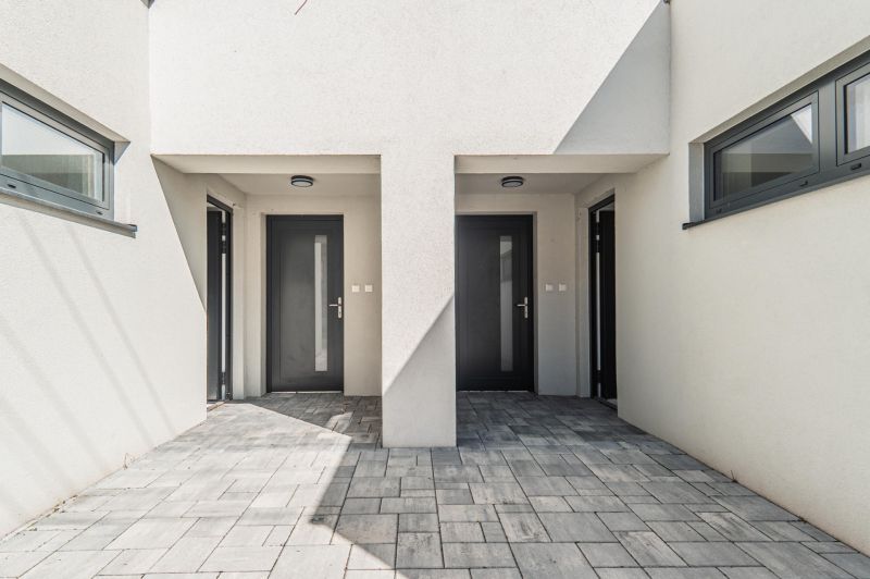 Entrance to the family house on Kľukatá Street, Bratislava - Prievoz, with stone paving.