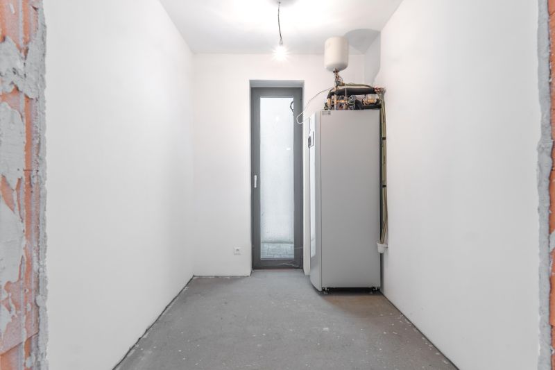 Technical room with a boiler and white walls in a family house.
