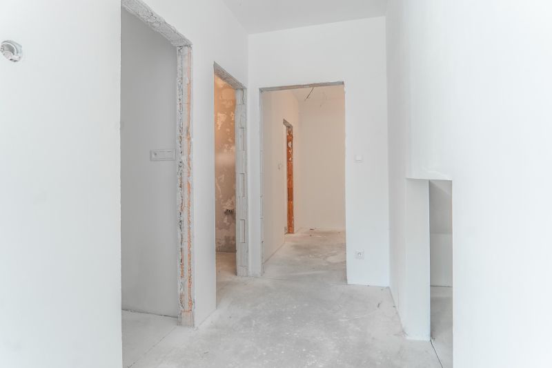 A family house with white walls and visible raw construction elements, floor ready for finishing.
