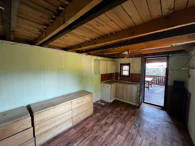 Interior with cabinets, kitchen unit, and floor with wood decor. Gardens.