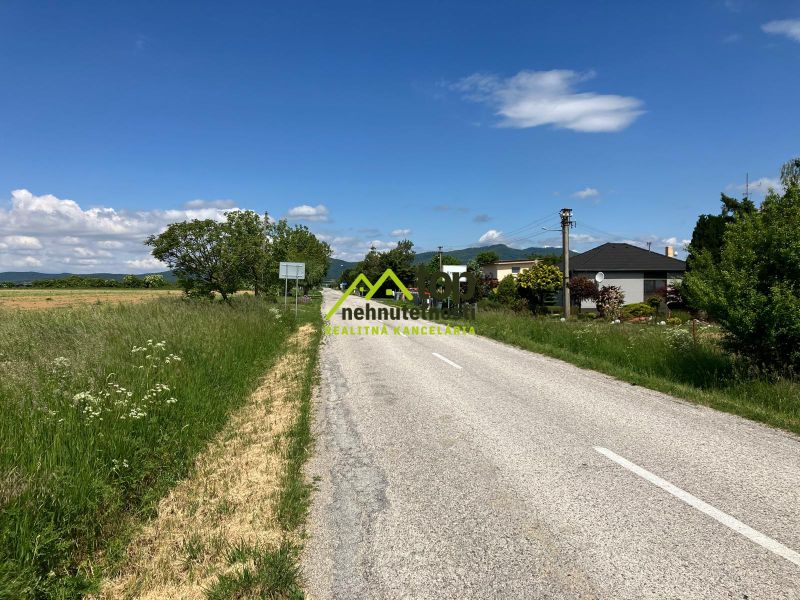 Road in the village of Krtovce, suitable for plots - housing, with green plots on the sides.