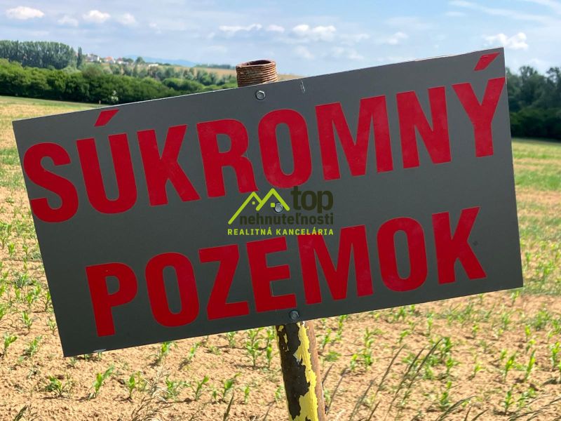 A private plot in Krtovce surrounded by greenery and blue skies, ideal for living.