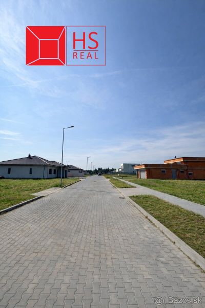 Street in Dvory nad Žitavou, Plots - residential, with unfinished houses and sidewalks.
