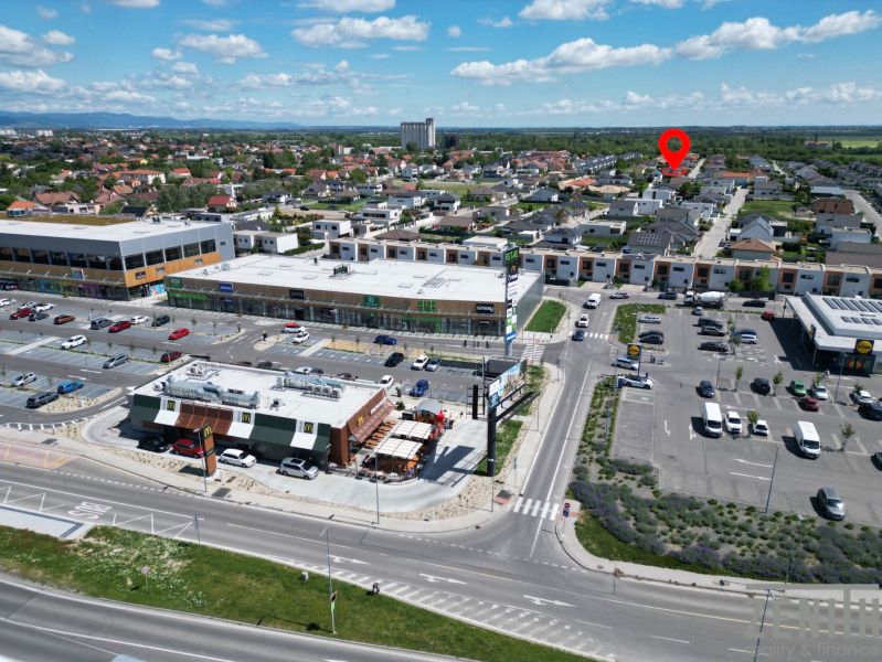 Shopping center, parking lot, and family houses in Bratislava - Podunajské Biskupice.