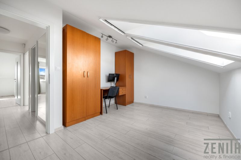 A bright room in a family house with two wardrobes and a table, wooden floor decor.