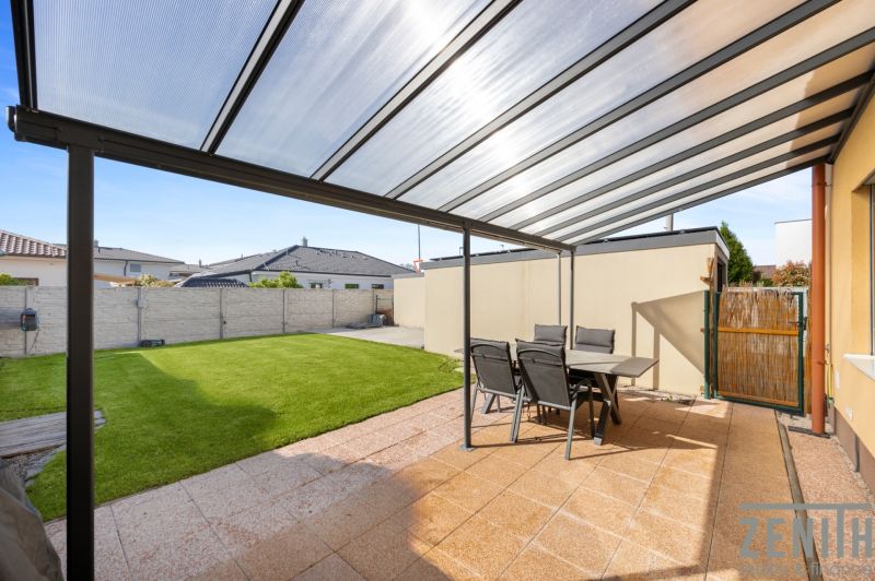 Covered terrace with seating and lawn in a family house in Bratislava - Podunajské Biskupice.