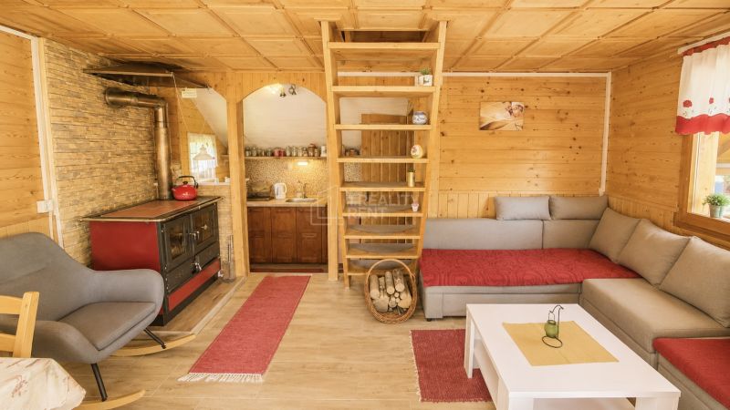 Wooden cabin with a warm interior, fireplace, and wooden decor flooring.