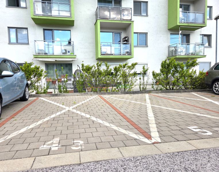 Parking lot in front of the residential building on Jurská Street, Bratislava - Nové Mesto.