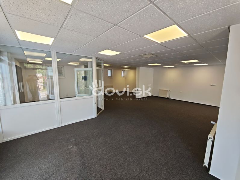 Offices with white walls and a glass partition, floor with carpet decor.