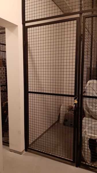Wire lockable storage spaces in a 2-room apartment.