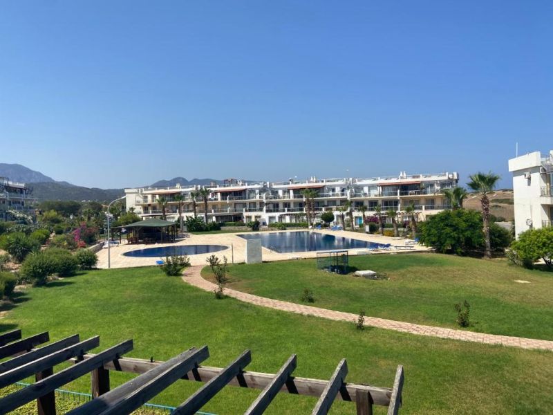 Complex of 2-bedroom apartments in Tatlisu with a swimming pool and well-maintained gardens.